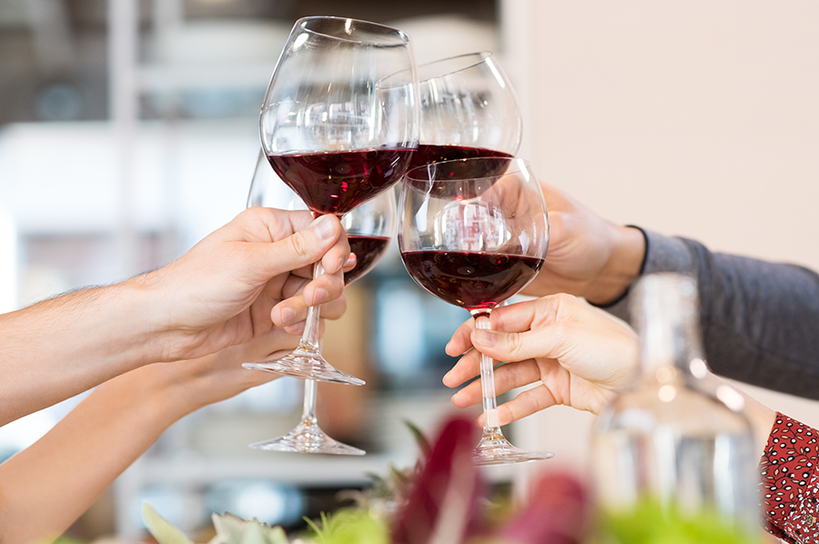 Friends toasting in the Art Plaza social center