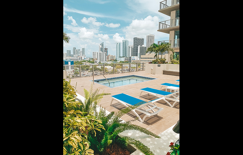 Large swimming pool deck with Miami skyline views